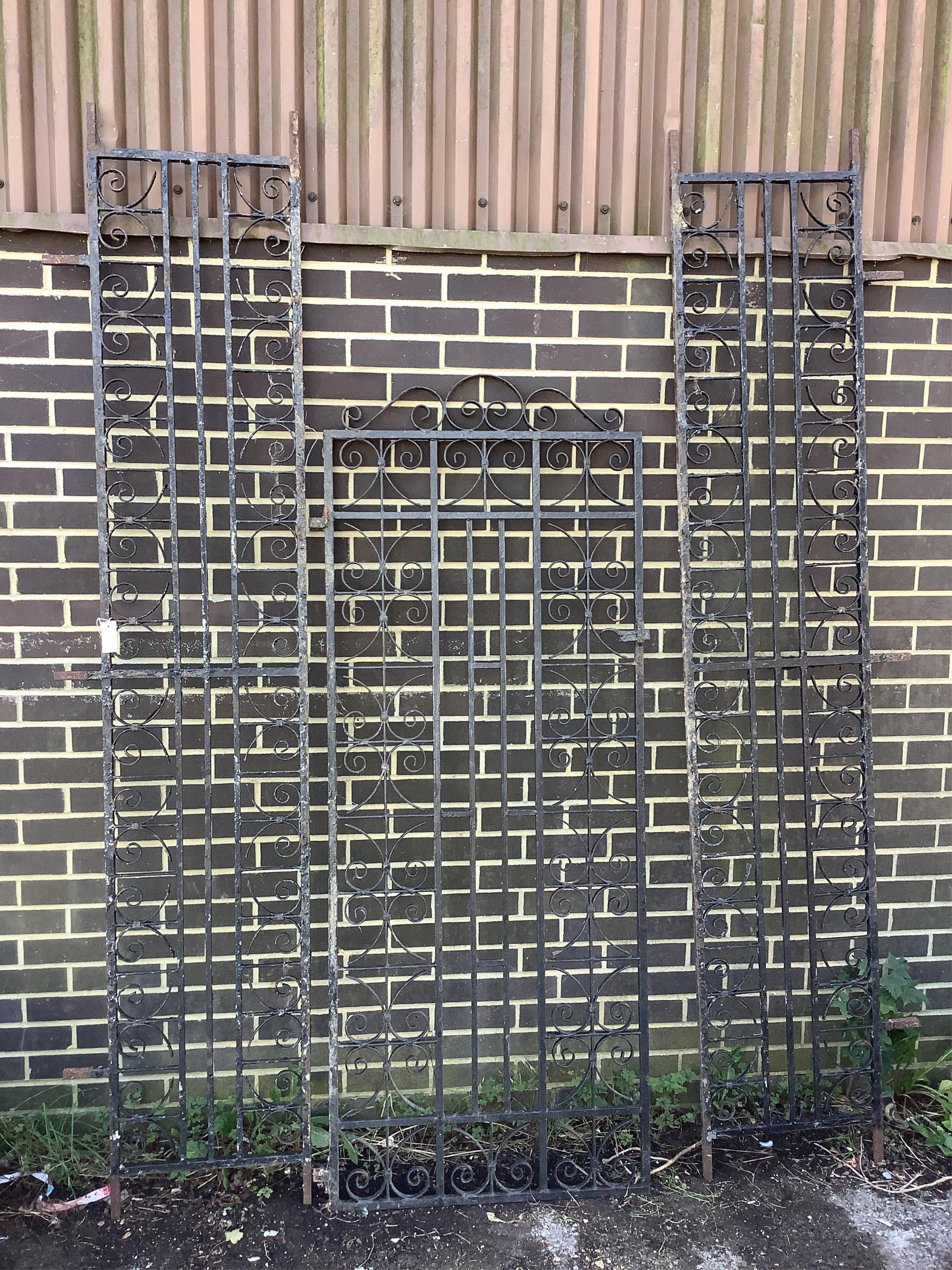 A wrought iron garden gate with side panels, combined width 168cm. Condition - fair